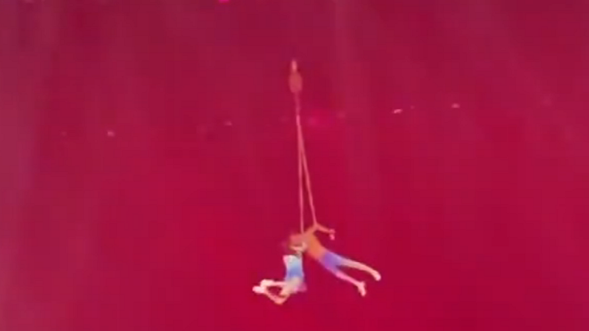 Chinese acrobat dangling in the air