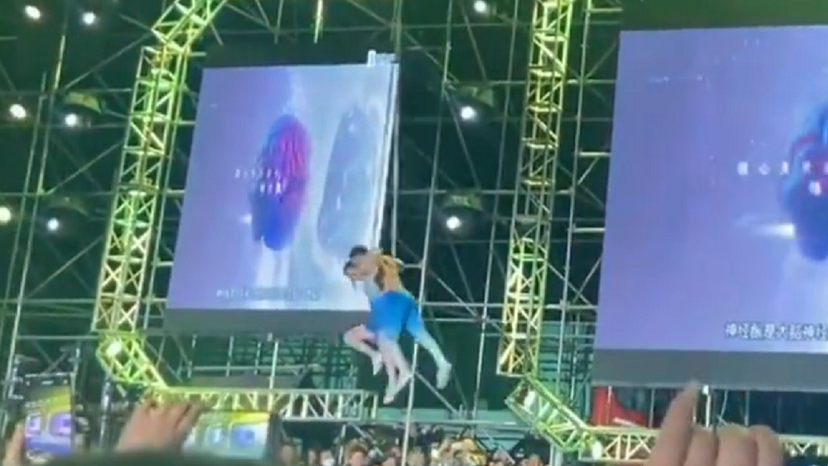 Chinese acrobat couple lifted off the ground
