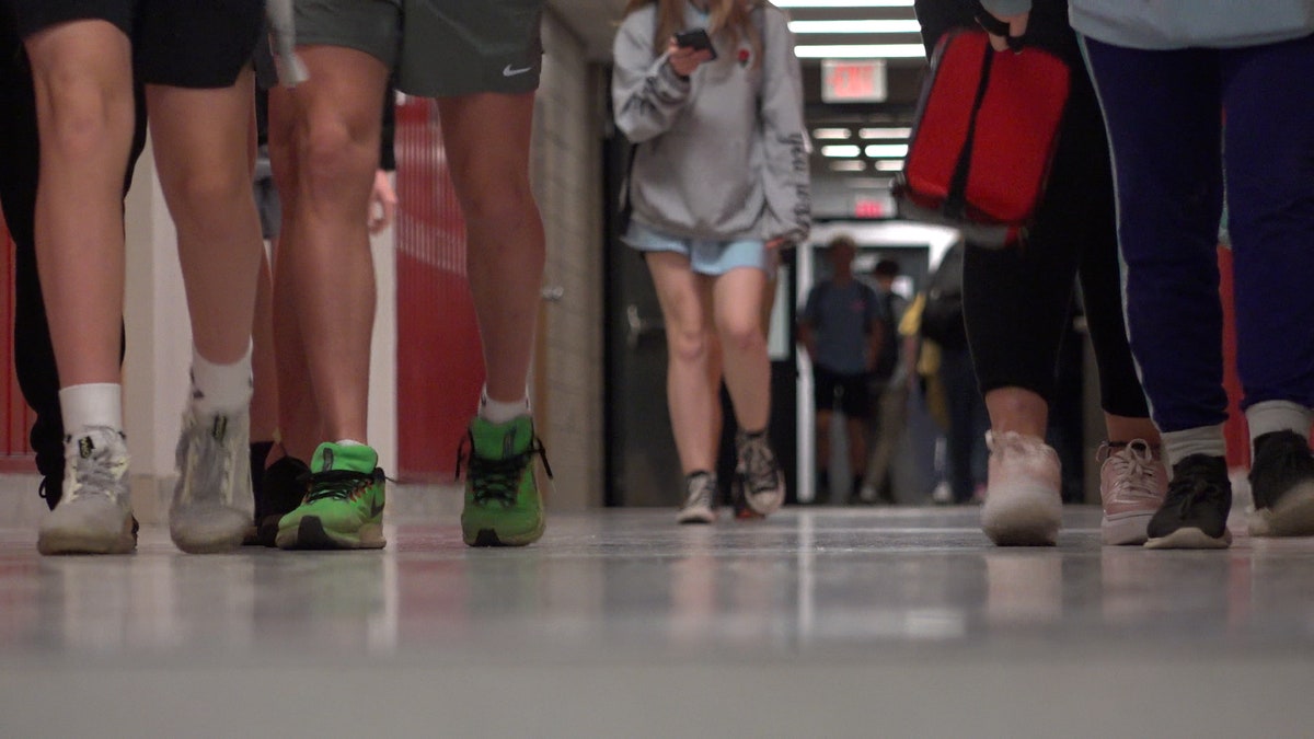 High school students walk down the hallway
