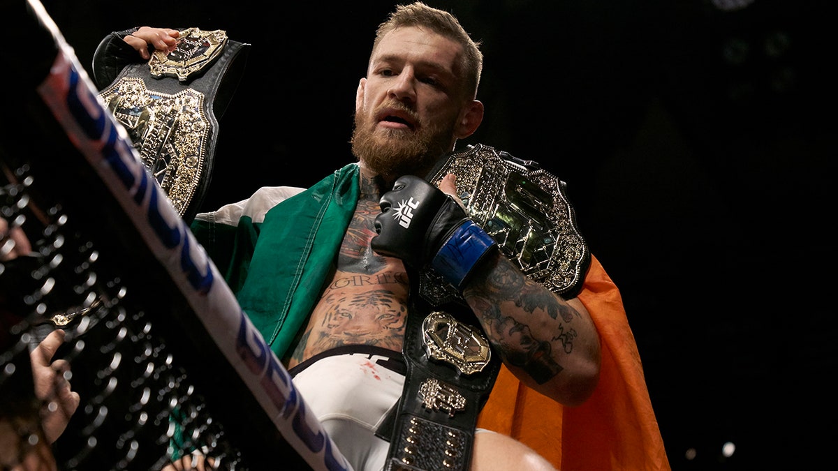 Conor McGregor holds the belts