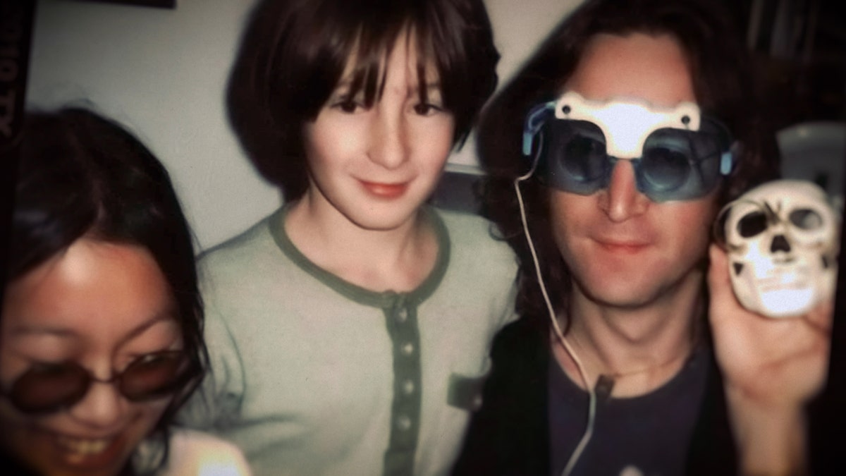 May Pang with John Lennon and Julian Lennon smiling for the camera