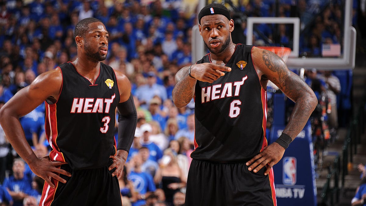 Dwyane Wade and LeBron James talk during a game