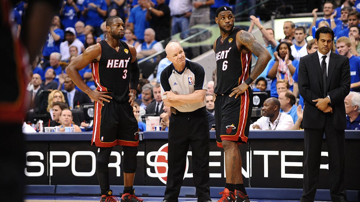 Dwyane Wade stands near LeBron James