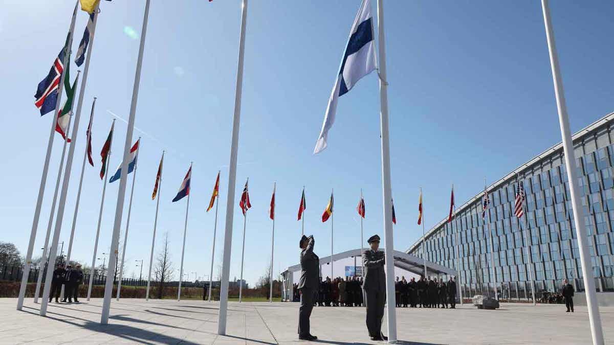 Militares levantam a bandeira da Finlândia