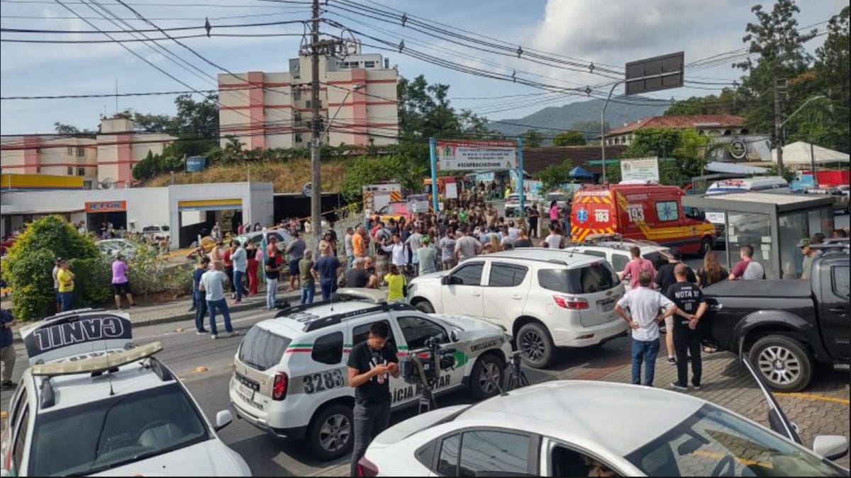 Law enforcement and media standing outside of a Brazilian daycare.
