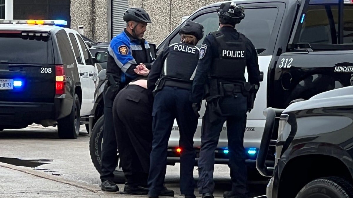 Police arresting suspect at all-ages drag brunch protest