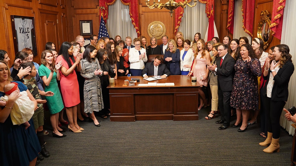 Pro-lifers surround DeSantis' desk as he signs Heartbeat Protection Act