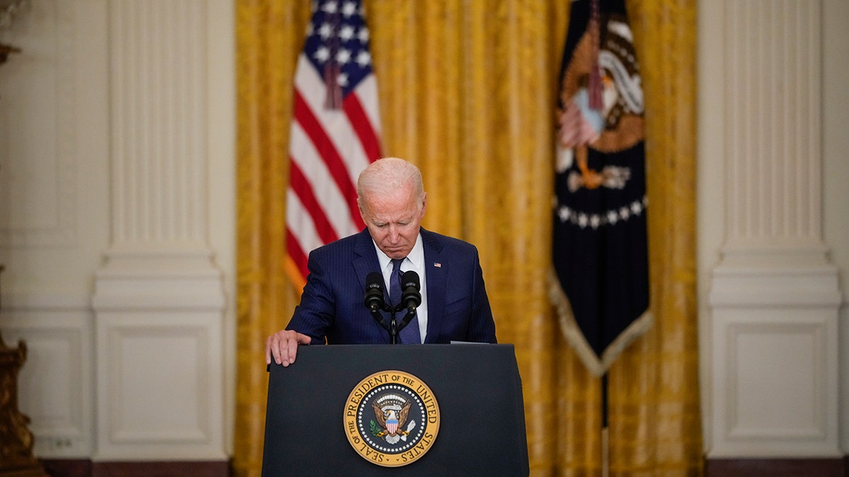 President Biden holding his head down