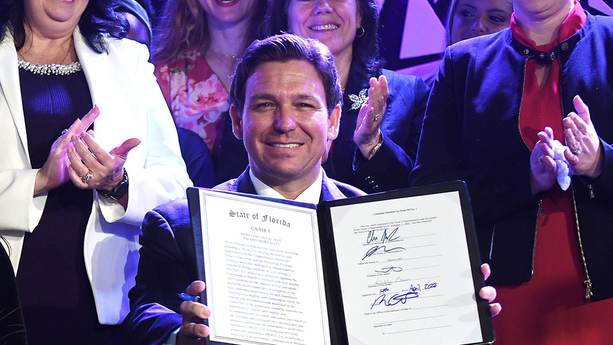 DeSantis holding a signed law