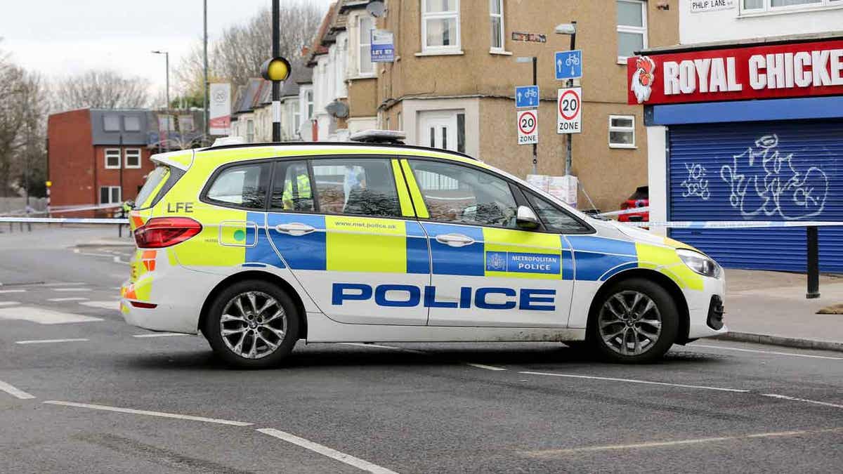Police car outside a cordon on Arnold Road in Tottenham
