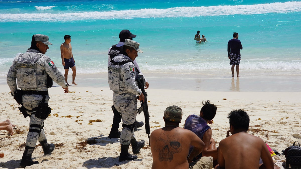 Mexican soldiers talk to spring breakers