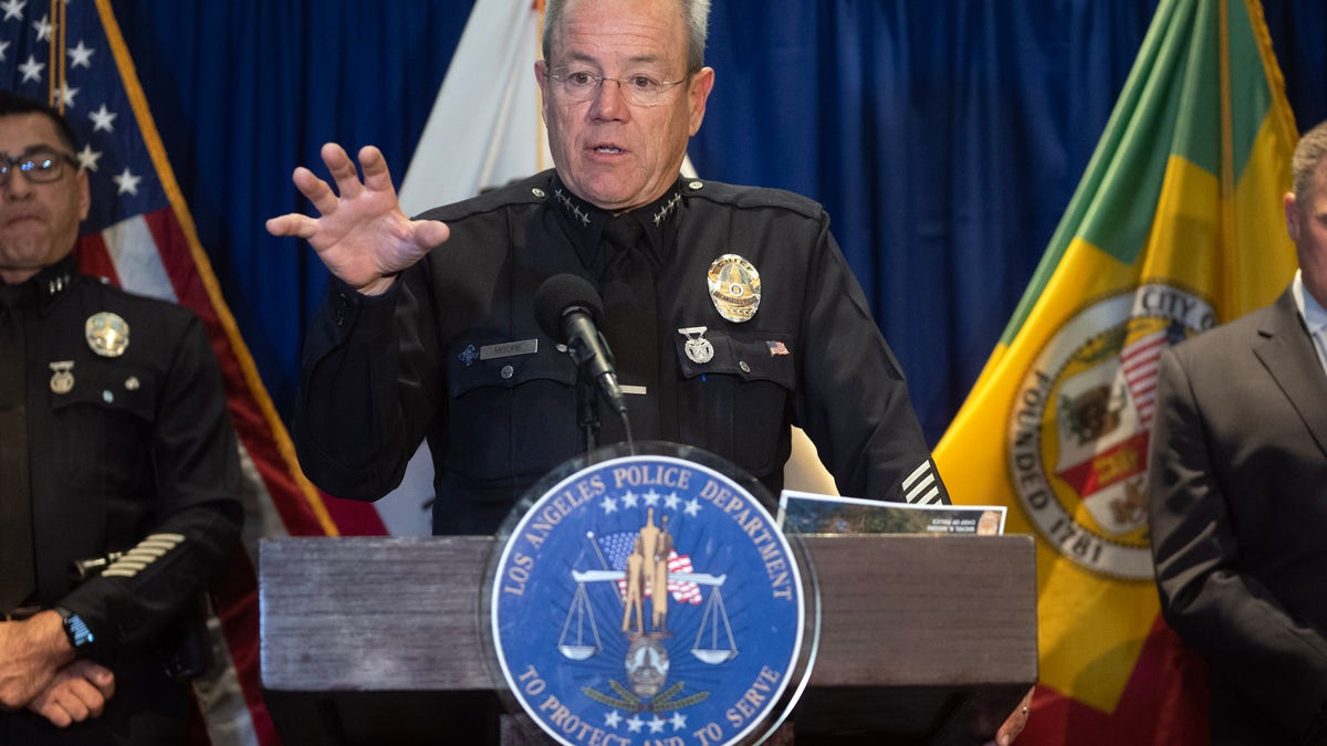 LAPD Chief Michel Moore speaks from podium