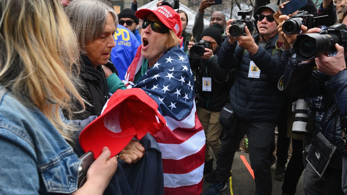 Pro and anti trump supporters face off during a protest outside of Manhattan Criminal Court in New York City on April 4, 2023. - Donald Trump will make an unprecedented appearance before a New York judge on April 4, 2023 to answer criminal charges that threaten to throw the 2024 White House race into turmoil. (Photo by ANGELA WEISS / AFP) (Photo by ANGELA WEISS/AFP via Getty Images)