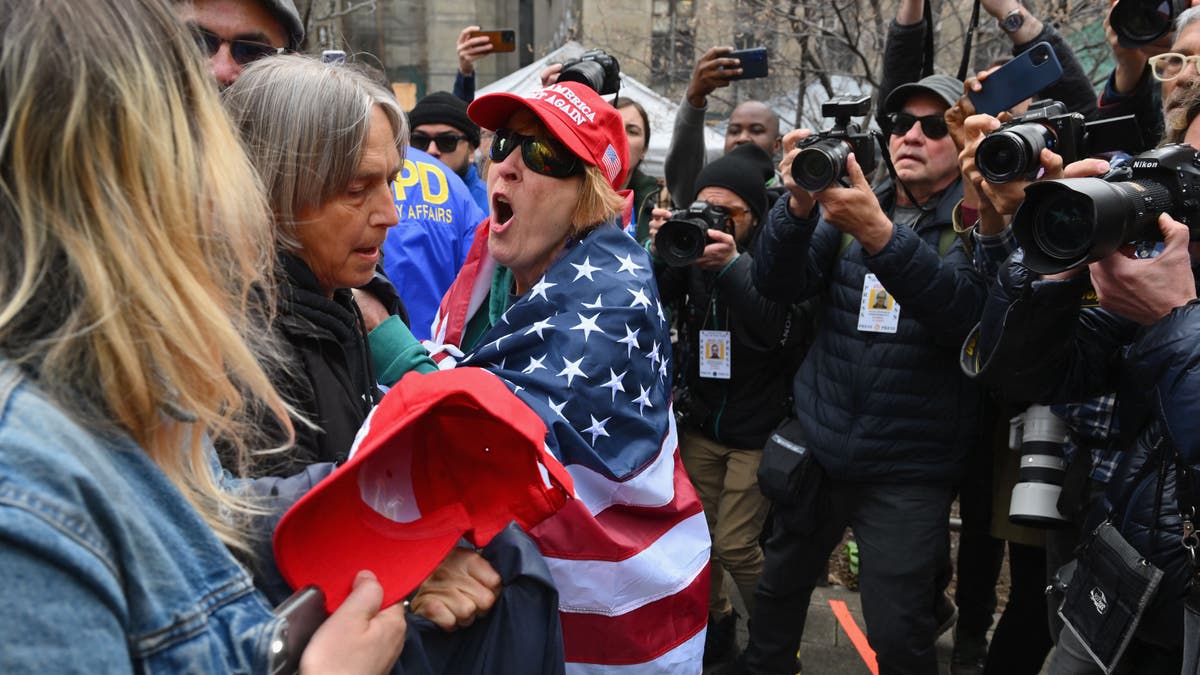 Pro and anti trump supporters face off during a protest outside of Manhattan Criminal Court in New York City on April 4, 2023. - Donald Trump will make an unprecedented appearance before a New York judge on April 4, 2023 to answer criminal charges that threaten to throw the 2024 White House race into turmoil. (Photo by ANGELA WEISS / AFP) (Photo by ANGELA WEISS/AFP via Getty Images)