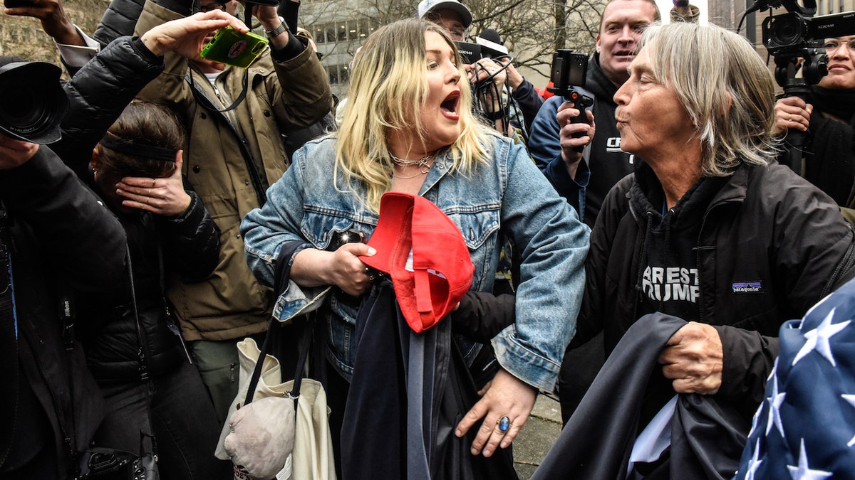A supporter of former US President Donald Trump, center, argues with a protestor outside criminal court in New York, US, on Tuesday, April 4, 2023. Trump, the first former US president to be indicted, will plead not guilty when he appears in a Manhattan state court Tuesday to face criminal charges, his defense lawyer said. Photographer: Stephanie Keith/Bloomberg