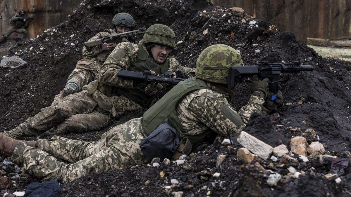 soldiers lying prone with rifles in Ukraine