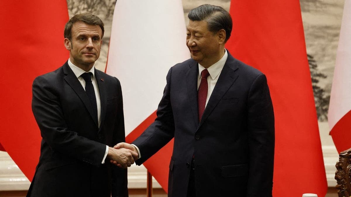 Macron and Xi greet each other