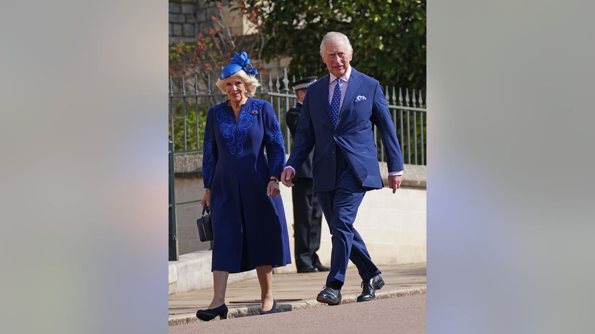 Queen Consort Camila in blue dress coat and King Charles III in blue suit