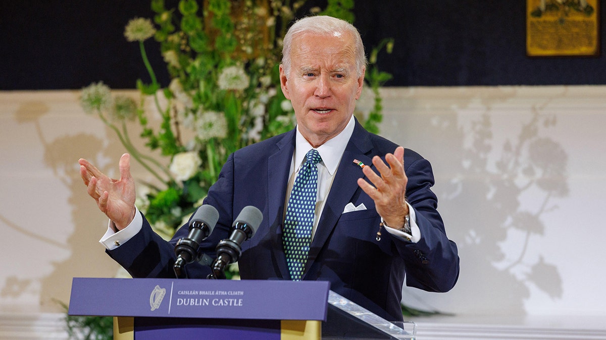 Biden speaking with is hands in the air