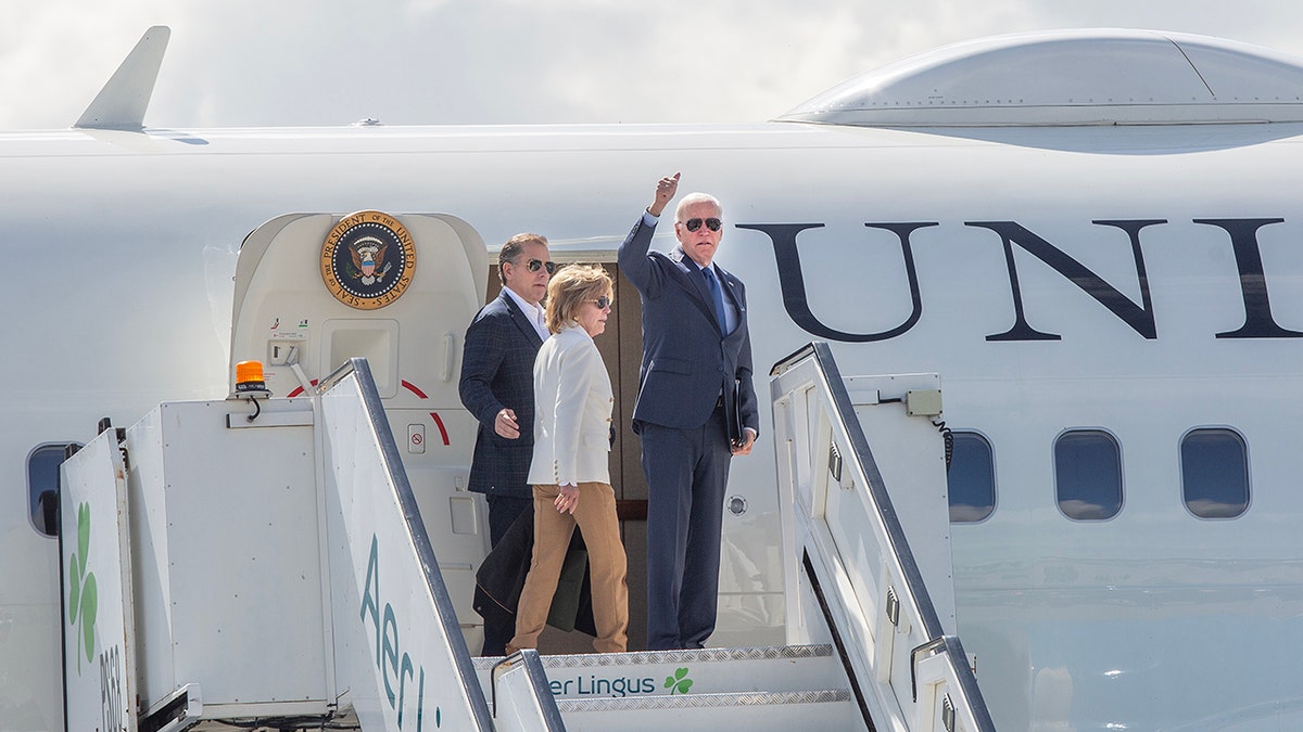Joe Biden waving while boarding Air Force One