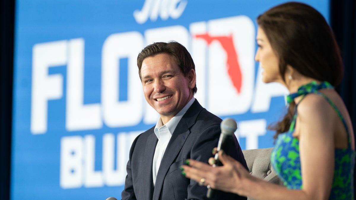 DeSantis sits on stage with his wife at Charleston event