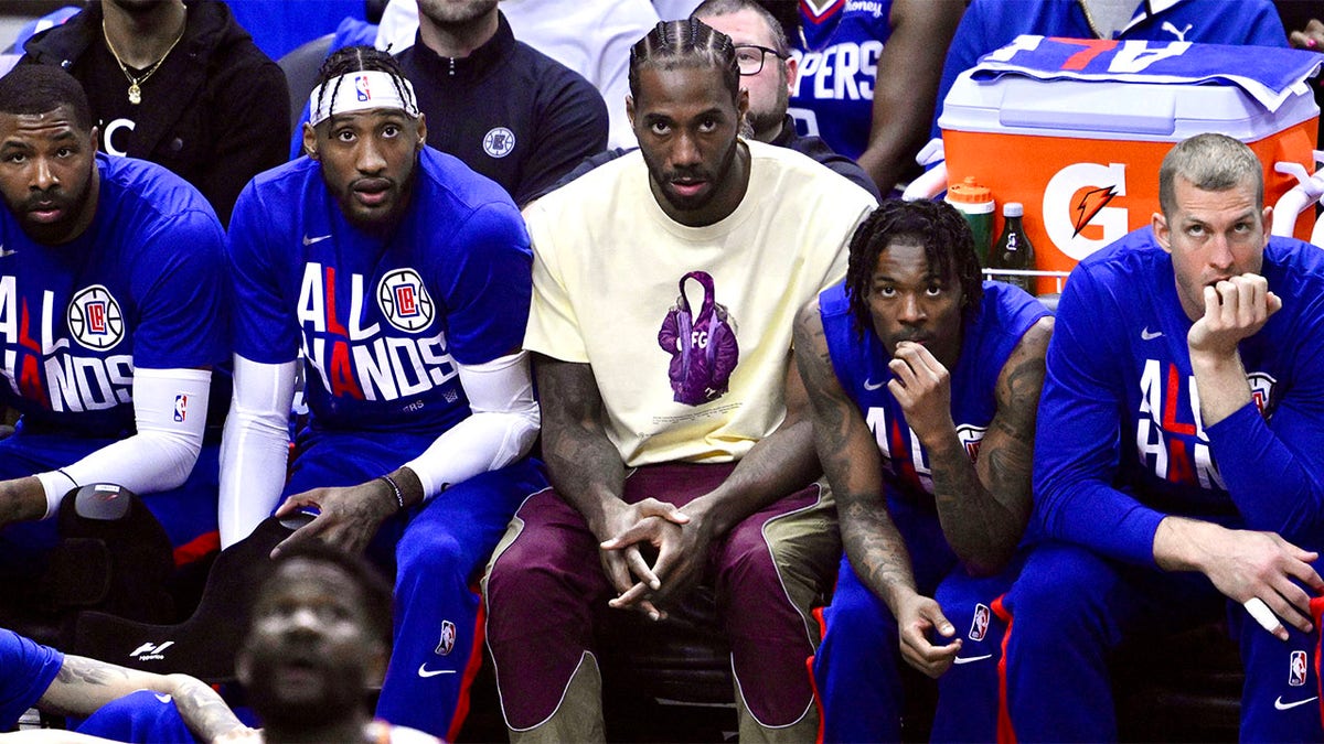 Kawhi Leonard looks on from the bench during a playoff game