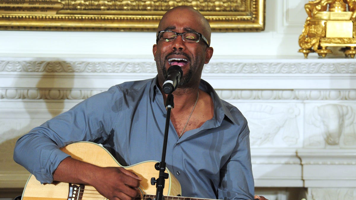 Darius Rucker plays guitar and sings at a performance in the White House.
