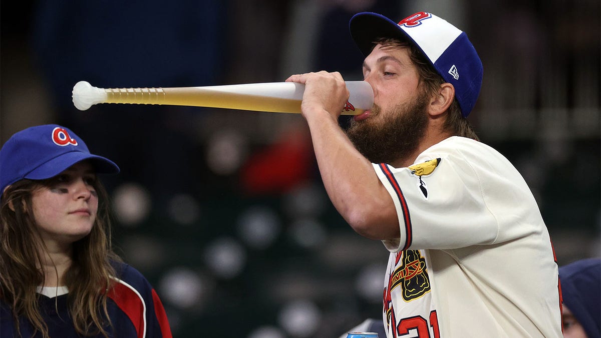 A Braves fan drinks a beer