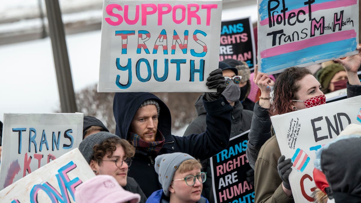 pro-trans youth demonstrators holding signs