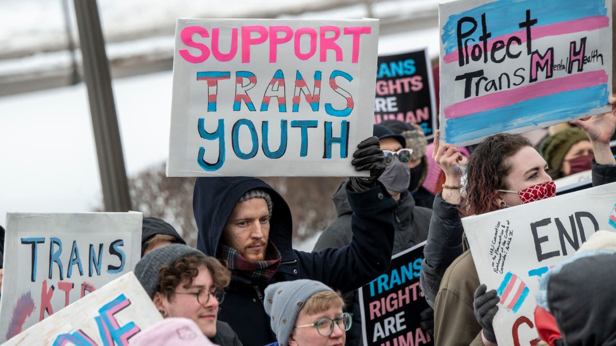 pro-trans youth demonstrators holding signs