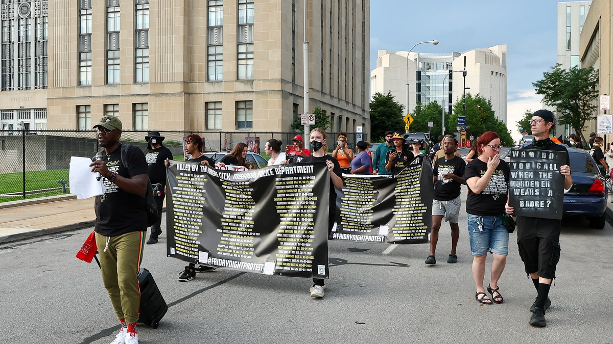 Protestors marching through the street.