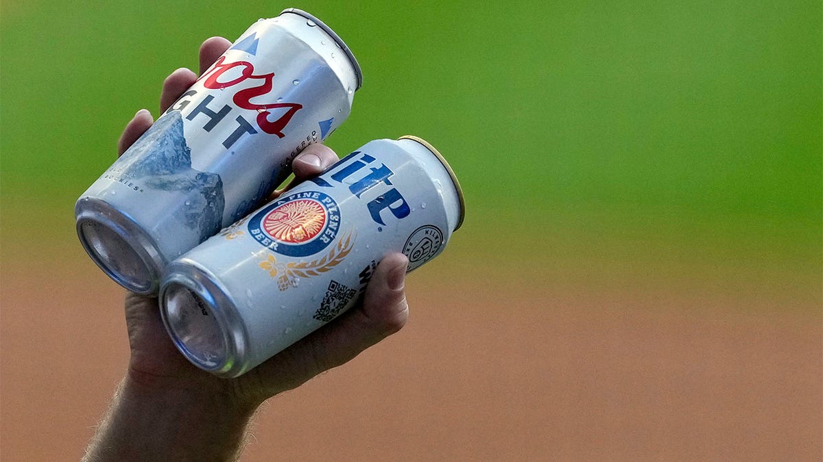 A beer vendor holds beer for sale