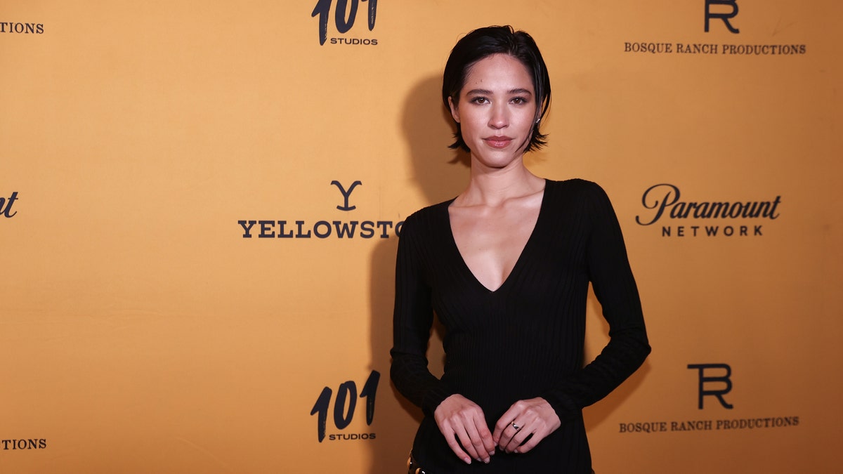Kelsey Asbille in a black dress with short hair on the red carpet