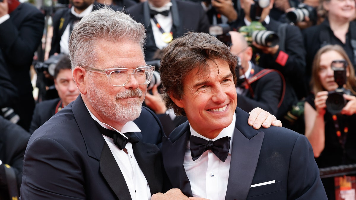 Christopher McQuarrie, left, said "you learn to accept" Tom Cruise taking on dangerous movie stunts.