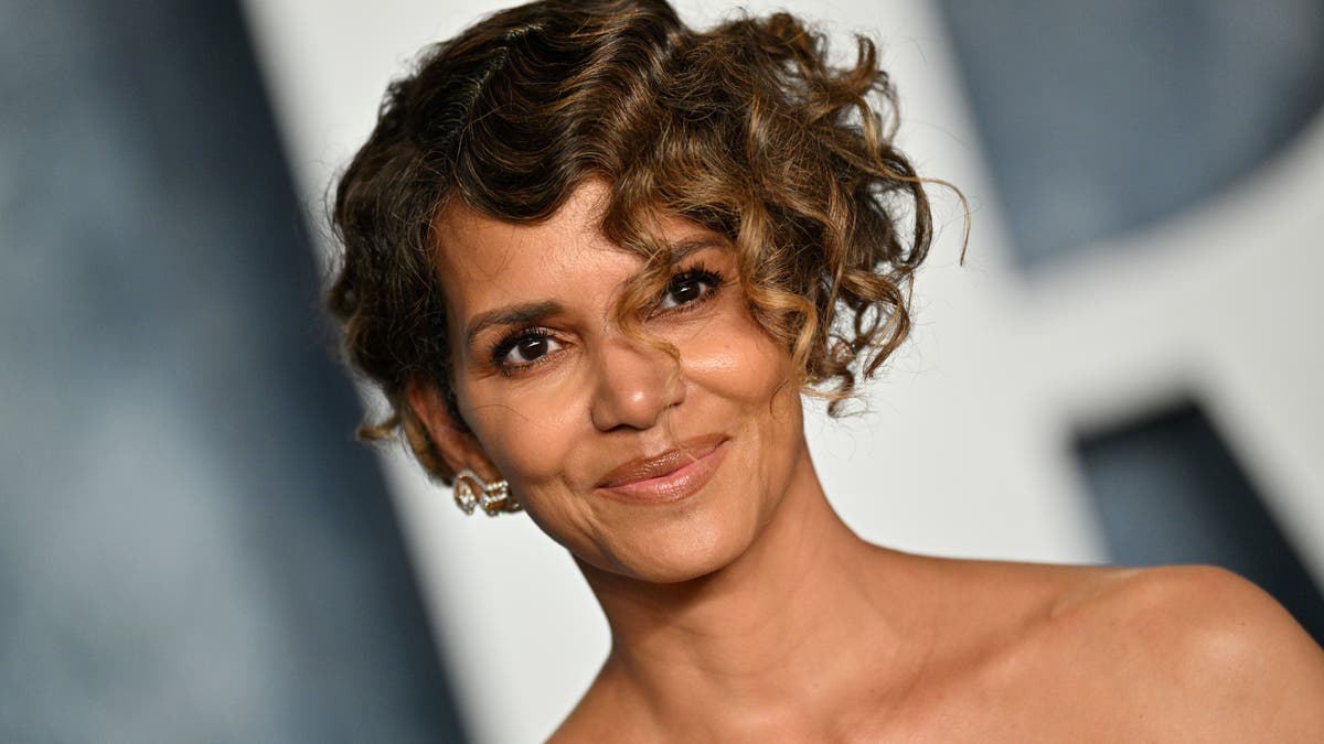 Close up of Halle Berry smiling with a short curly hair cut