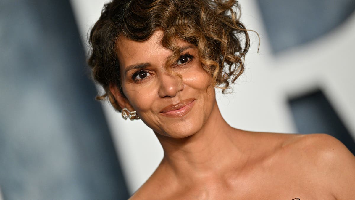 Close up of Halle Berry smiling with a short curly hair cut