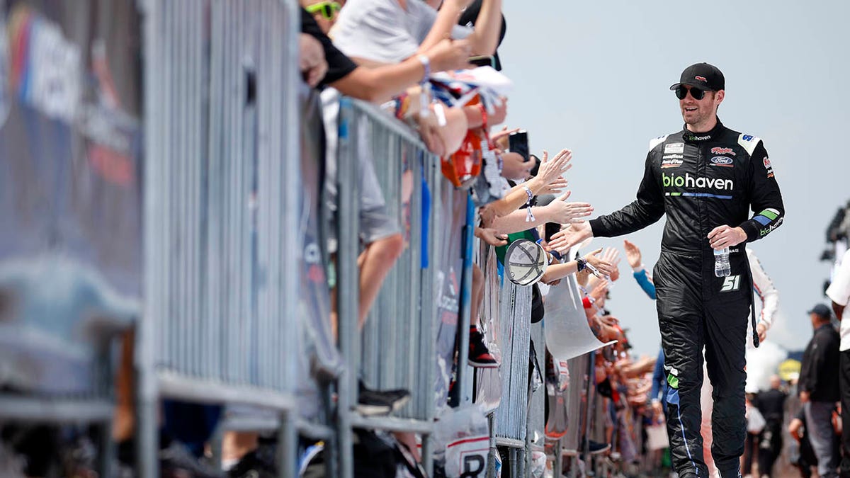 Cody Ware greets fans prior to the NASCAR Cup Series EchoPark Automotive Grand Prix