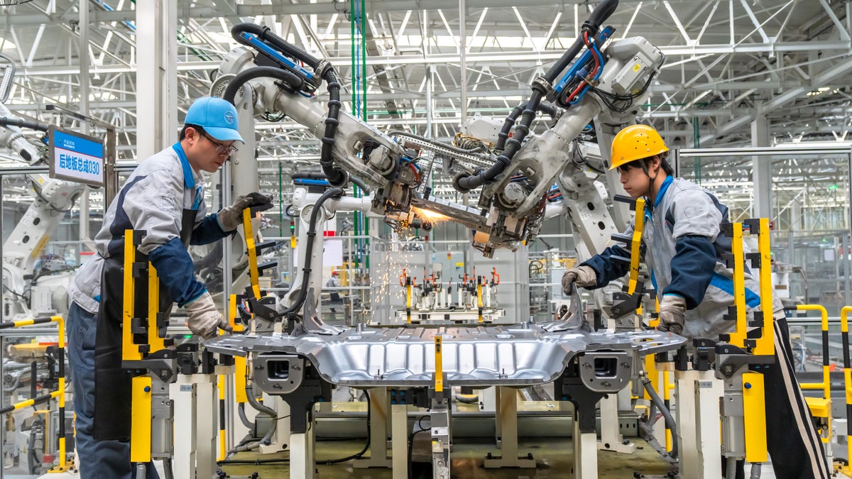 Workers assemble electric vehicles at a factory in Yuncheng, Shanxi Province of China, on March 28.