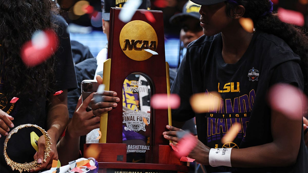 Angel Reese holds the national championship trophy