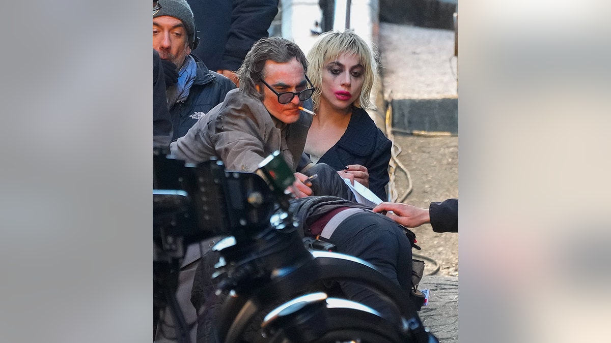 Joaquin Phoenix and Lady Gaga in respective Joker and Harley Quinn makeup on the set of "Joker: Folie à Deux" in New York City
