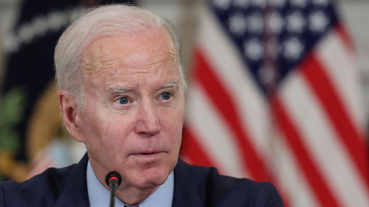 President Joe Biden, US flags in background