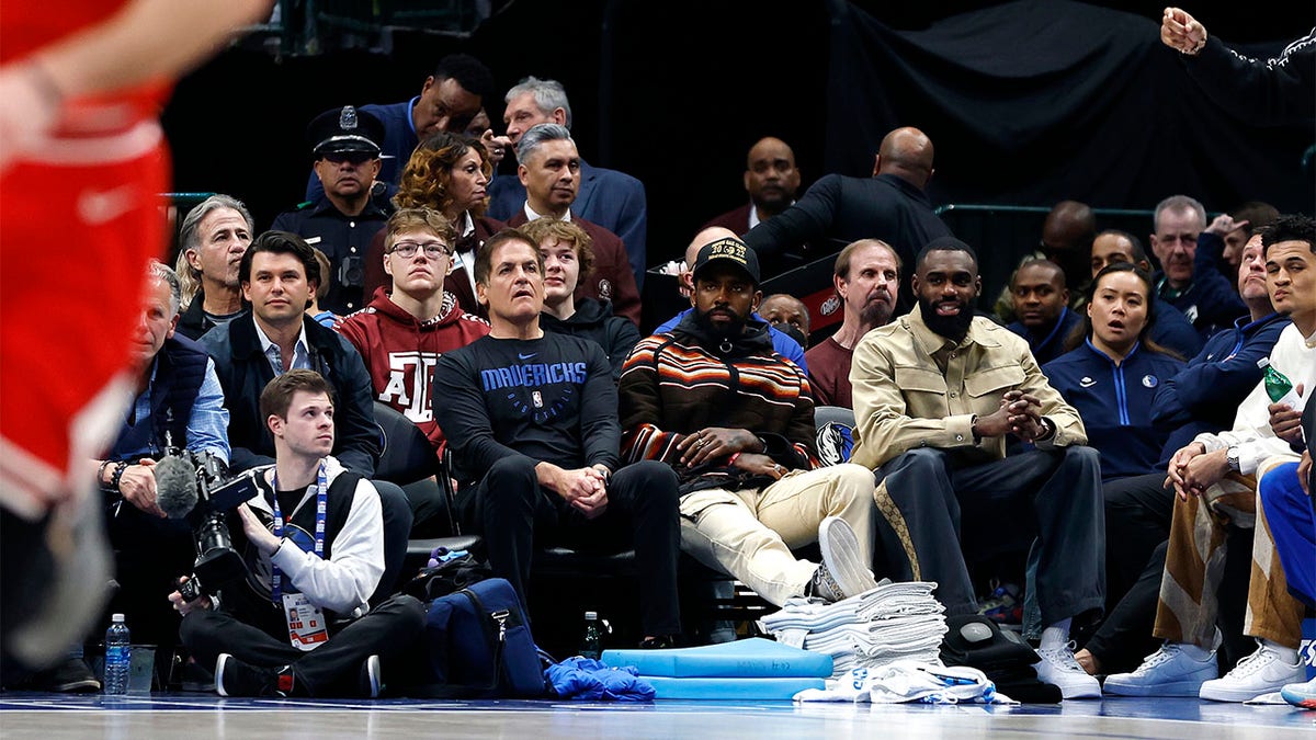 Mark Cuban and Kyrie Irving watch a game against the Bulls