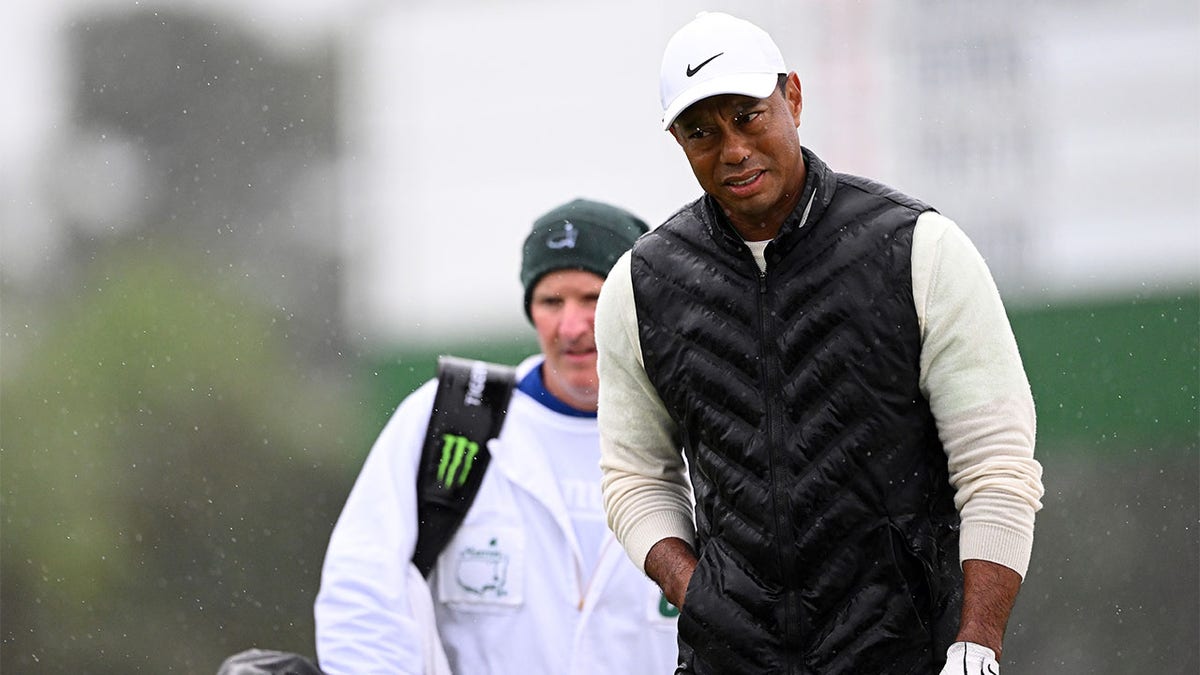 Tiger Woods plays in the rain at the Masters