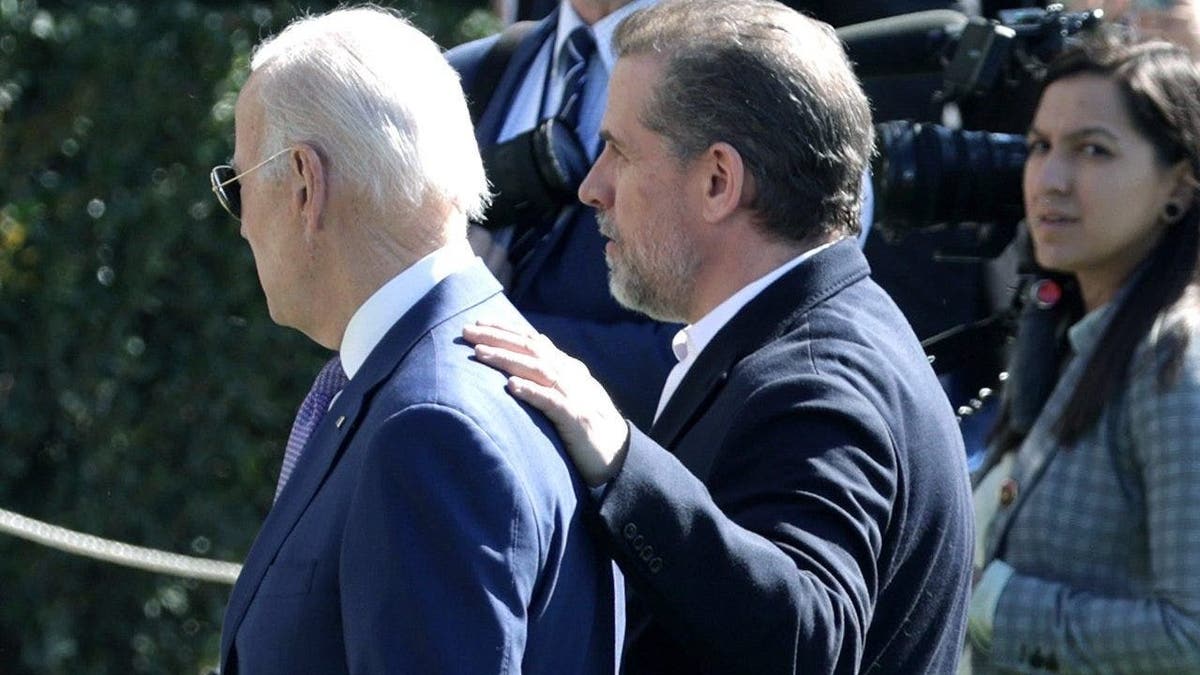 President Joe Biden (L) and his son Hunter Biden (2nd L)