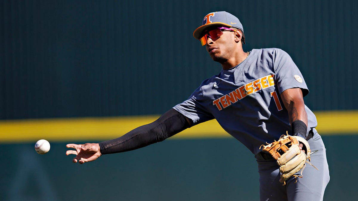 Christian Moore makes a throw to first base
