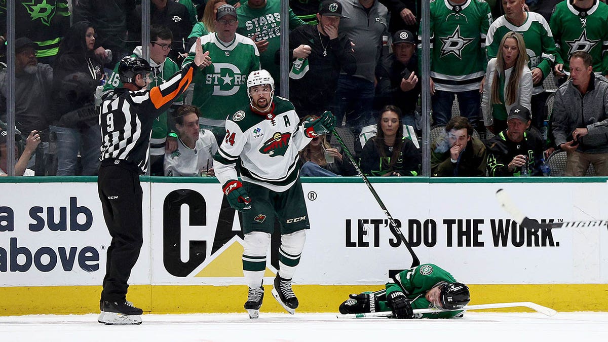 Joe Pavelski lays on the ice after getting hit by Matt Dumba