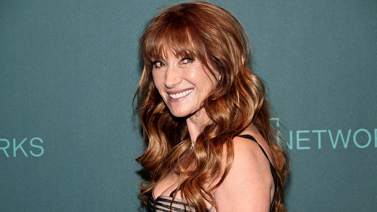 Jane Seymour looks back at the cameras on the red carpet in a black strappy dress