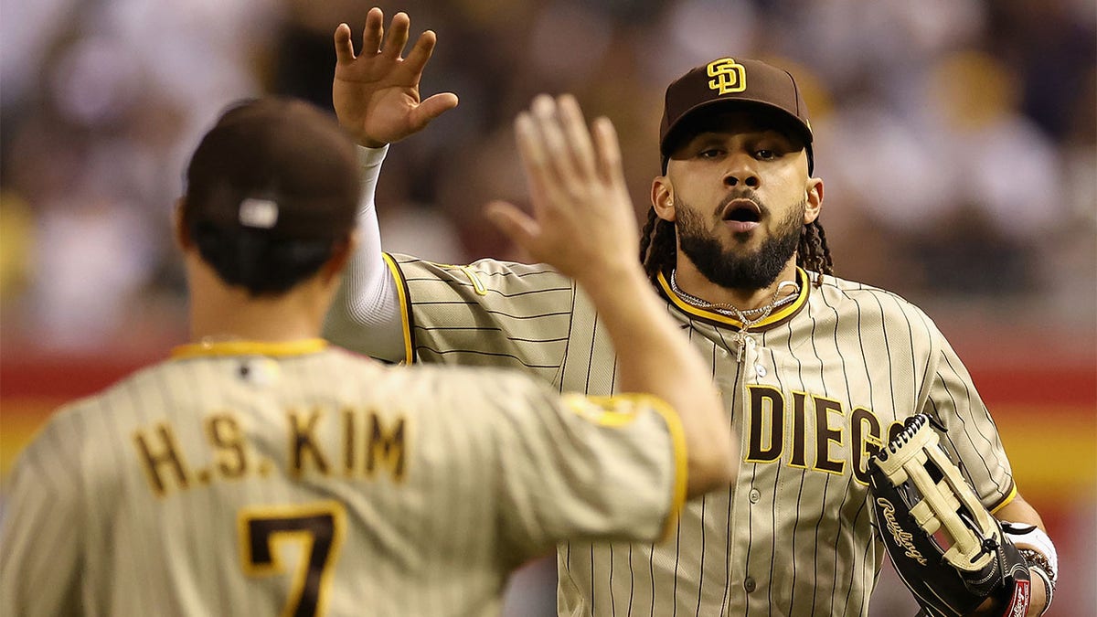 Fernando Tatis Jr. high fives a teammate