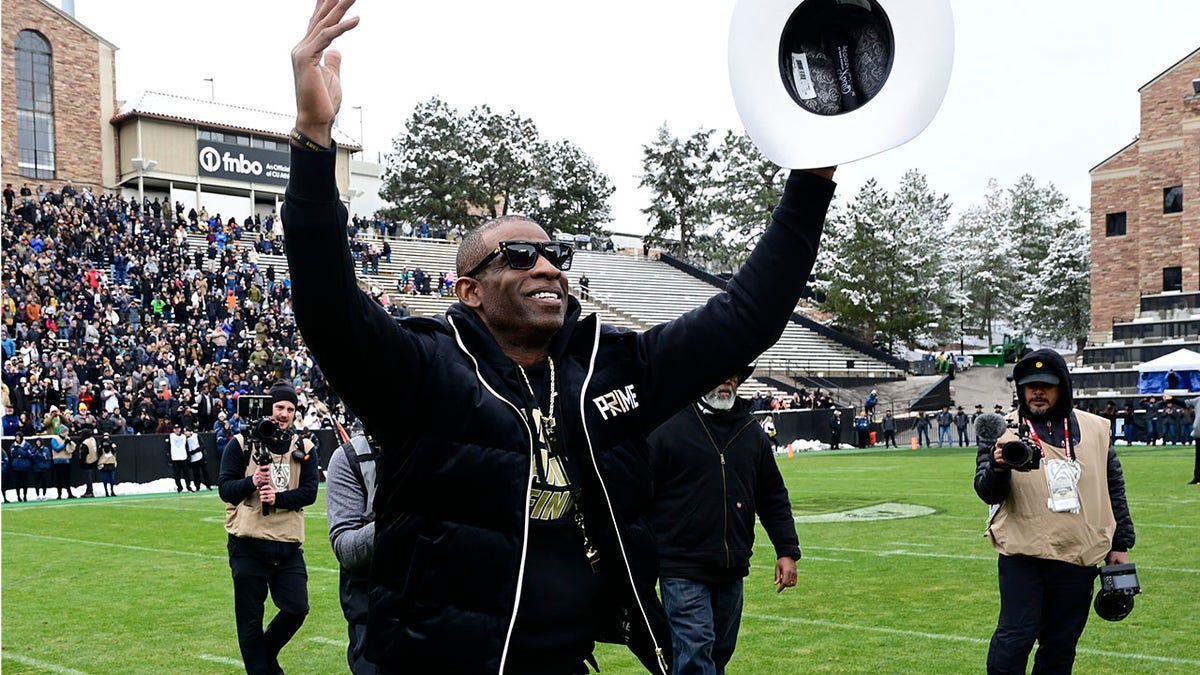 Deion Sanders waves to the Colorado crowd