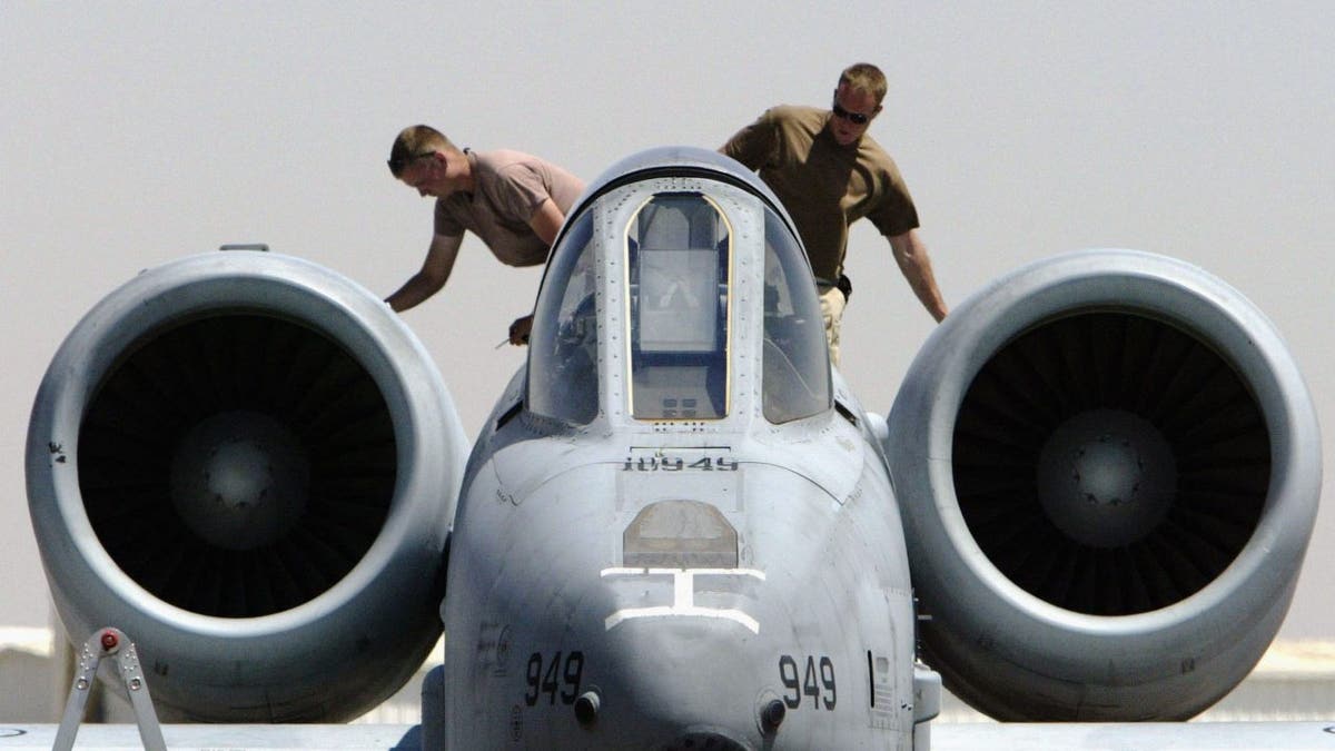 U.S. Air Force ground maintenance crewmen check over the engines of an A10 Thunderbolt "Warthog" after it had returned from a mission.
